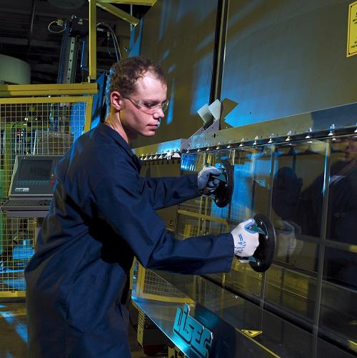 Male worker removes glass from an IG line